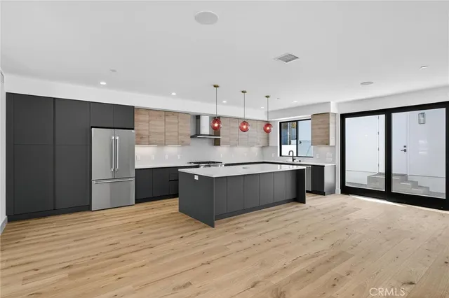 a kitchen with stainless steel appliances kitchen island wooden cabinets and granite counter tops