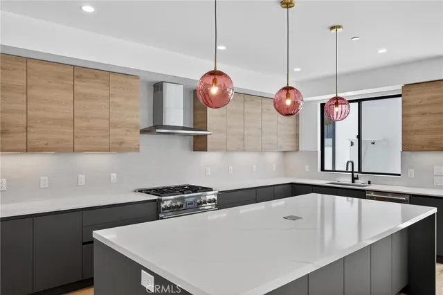 a kitchen with a sink a counter space cabinets and appliances