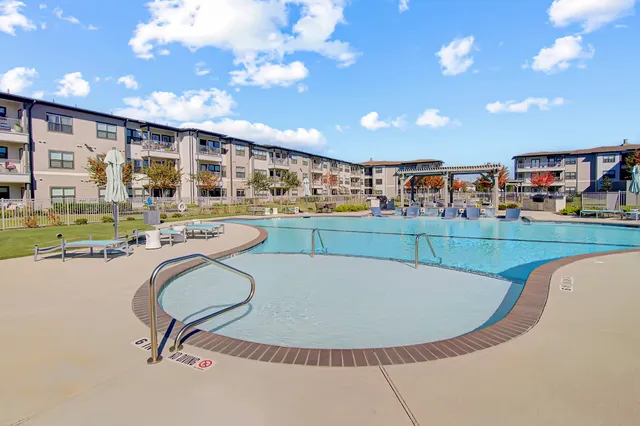a view of a swimming pool and outdoor kitchen