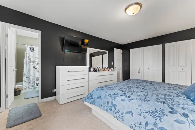 a bedroom with a bed and a dresser