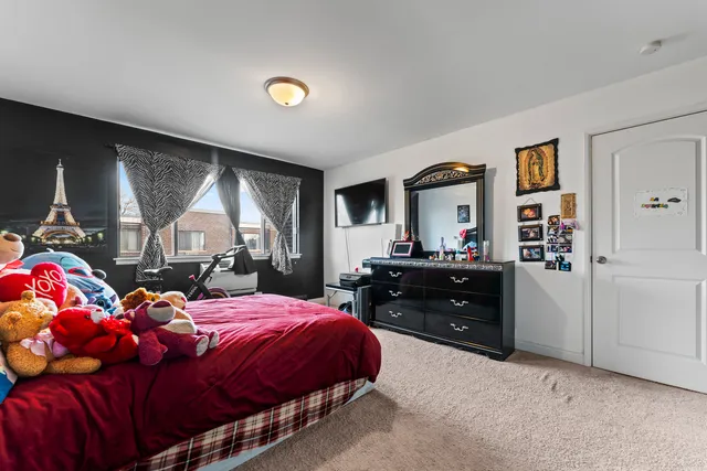 a bedroom with a bed and a dresser