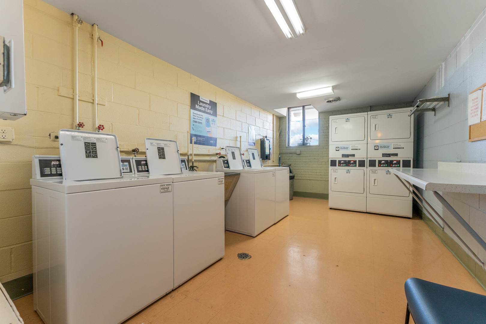 4623 North Chester Avenue, Unit 410 Chicago, IL 60656 - Photo 18 of 20 a kitchen with kitchen island a counter top space a sink stainless steel appliances and cabinets