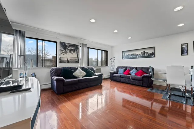 a living room with furniture window and a wooden floor