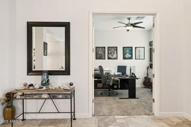 a kitchen with white cabinets and chandelier