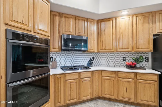 a view of walk in closet with clothes