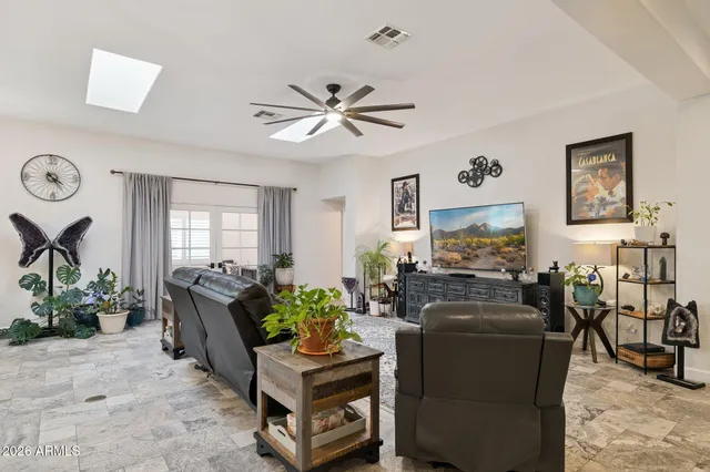 a backyard of a house with fire pit and outdoor seating