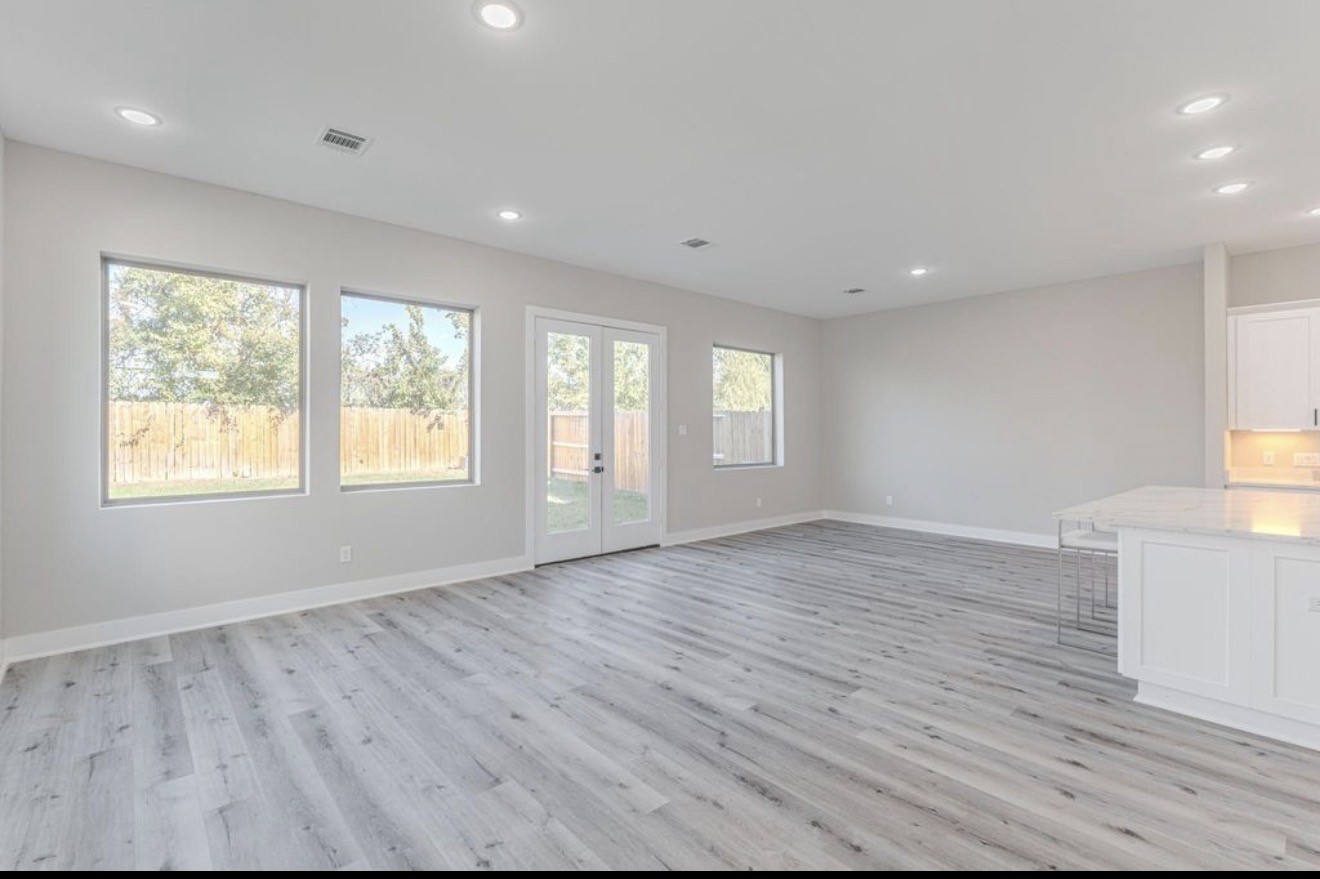 15038 Wunderlust Houston, TX 77069 - Photo 3 of 9 an empty room with wooden floor and windows