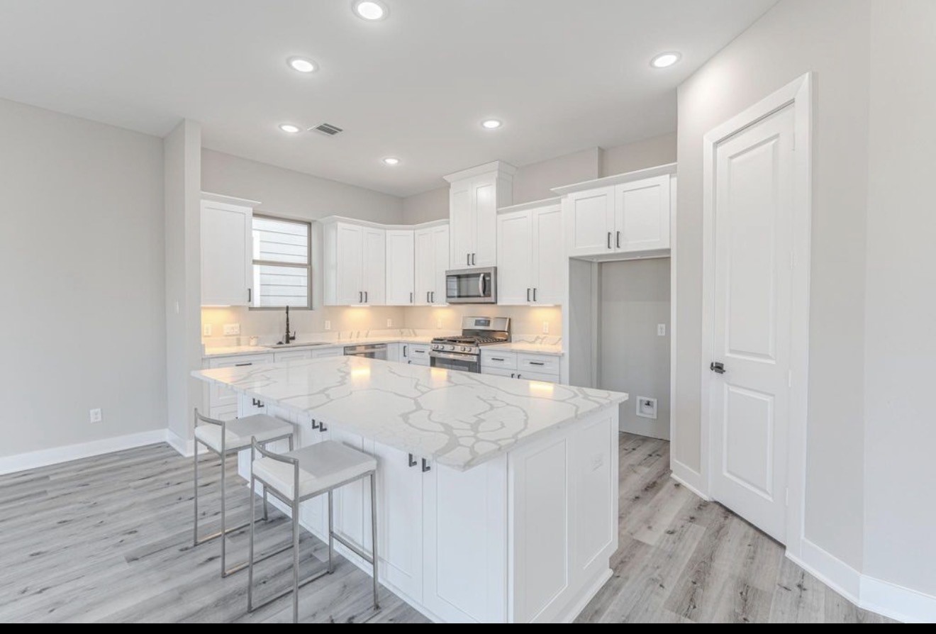 15038 Wunderlust Houston, TX 77069 - Photo 5 of 9 a large kitchen with kitchen island a sink a center island stainless steel appliances and a refrigerator