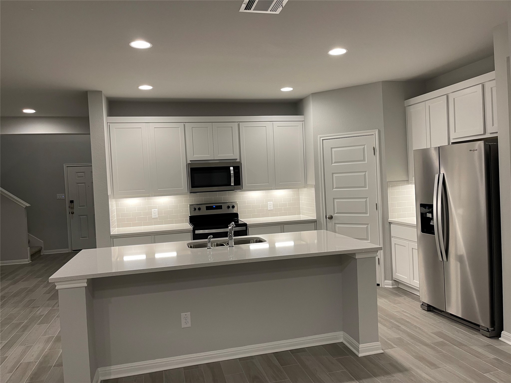 316 Mclintock Road Jarrell, TX 76537 - Photo 2 of 40 a kitchen with stainless steel appliances a refrigerator a stove and white cabinets