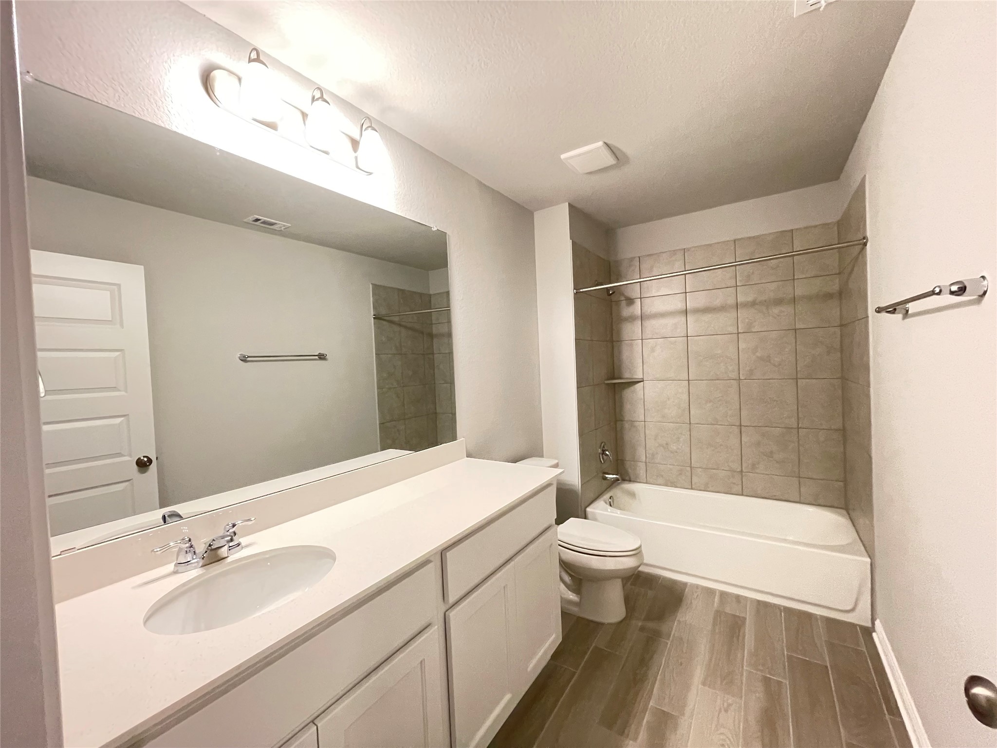 316 Mclintock Road Jarrell, TX 76537 - Photo 27 of 40 a bathroom with a granite countertop sink a toilet a mirror and bathtub