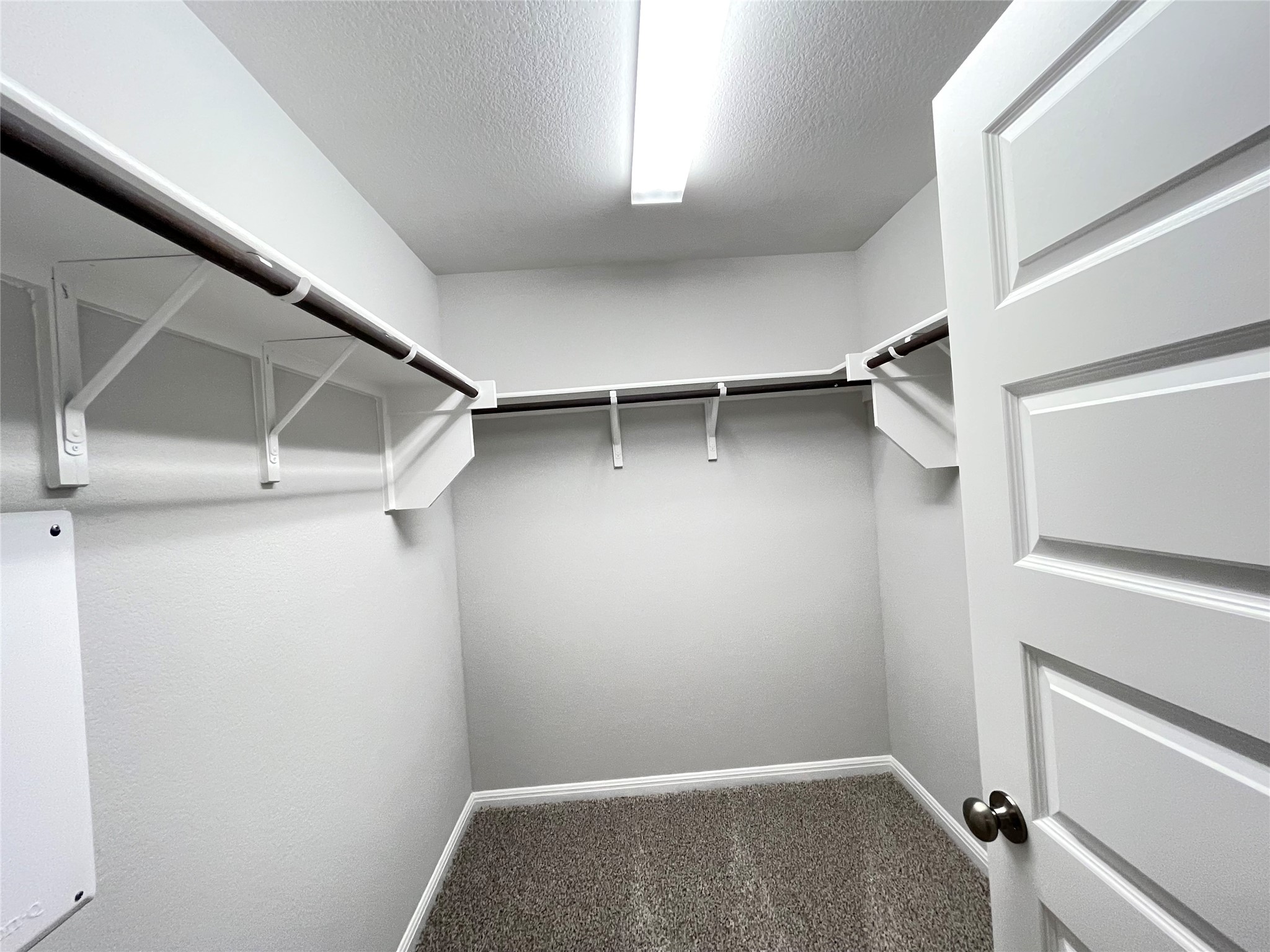 316 Mclintock Road Jarrell, TX 76537 - Photo 30 of 40 a view of walk in closet with empty racks