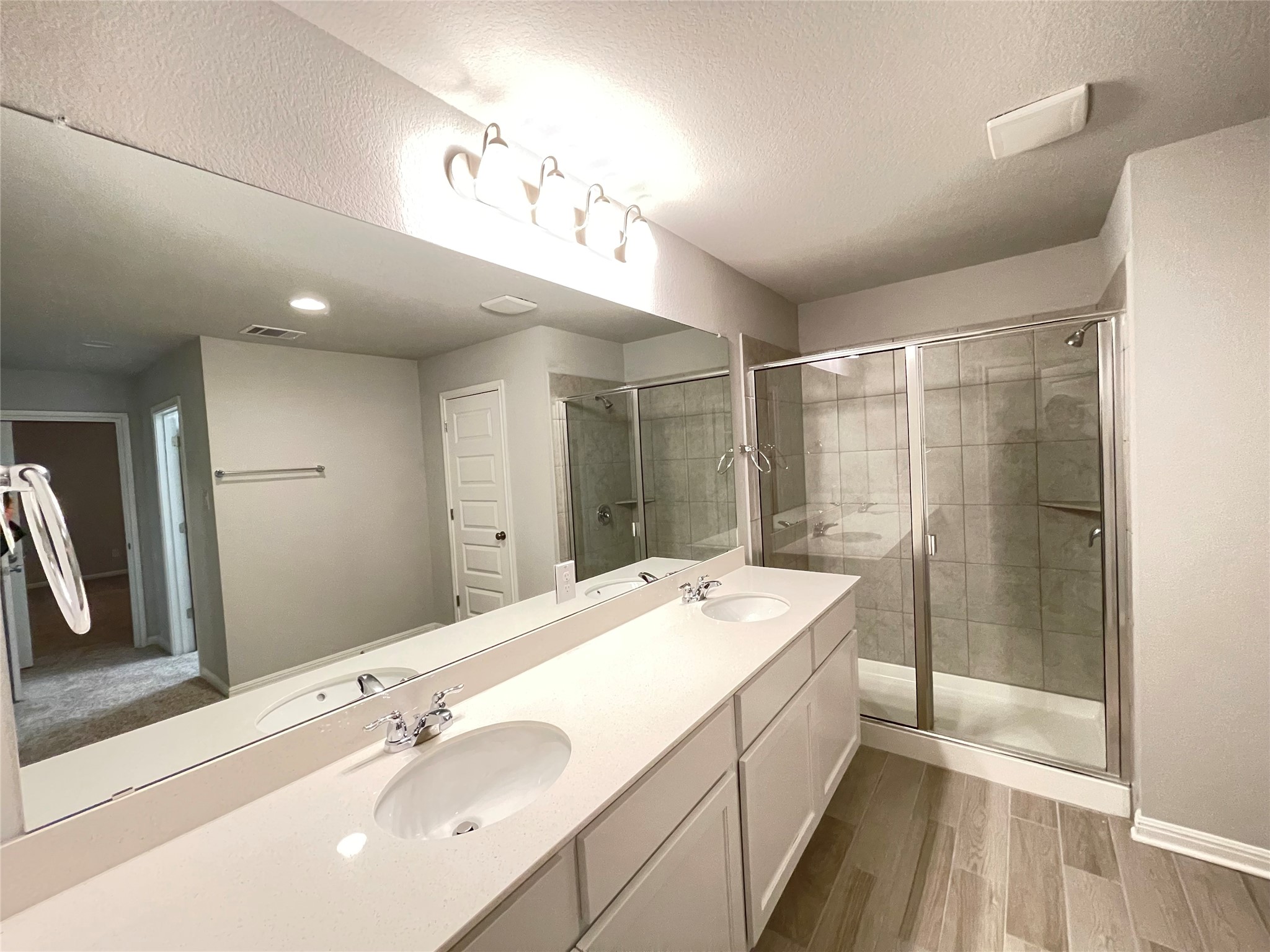 316 Mclintock Road Jarrell, TX 76537 - Photo 32 of 40 a spacious bathroom with a sink a large mirror and shower