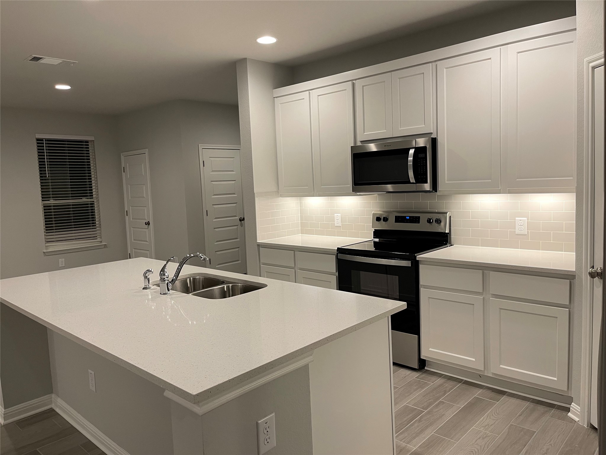 316 Mclintock Road Jarrell, TX 76537 - Photo 5 of 40 a kitchen with a sink a stove and microwave