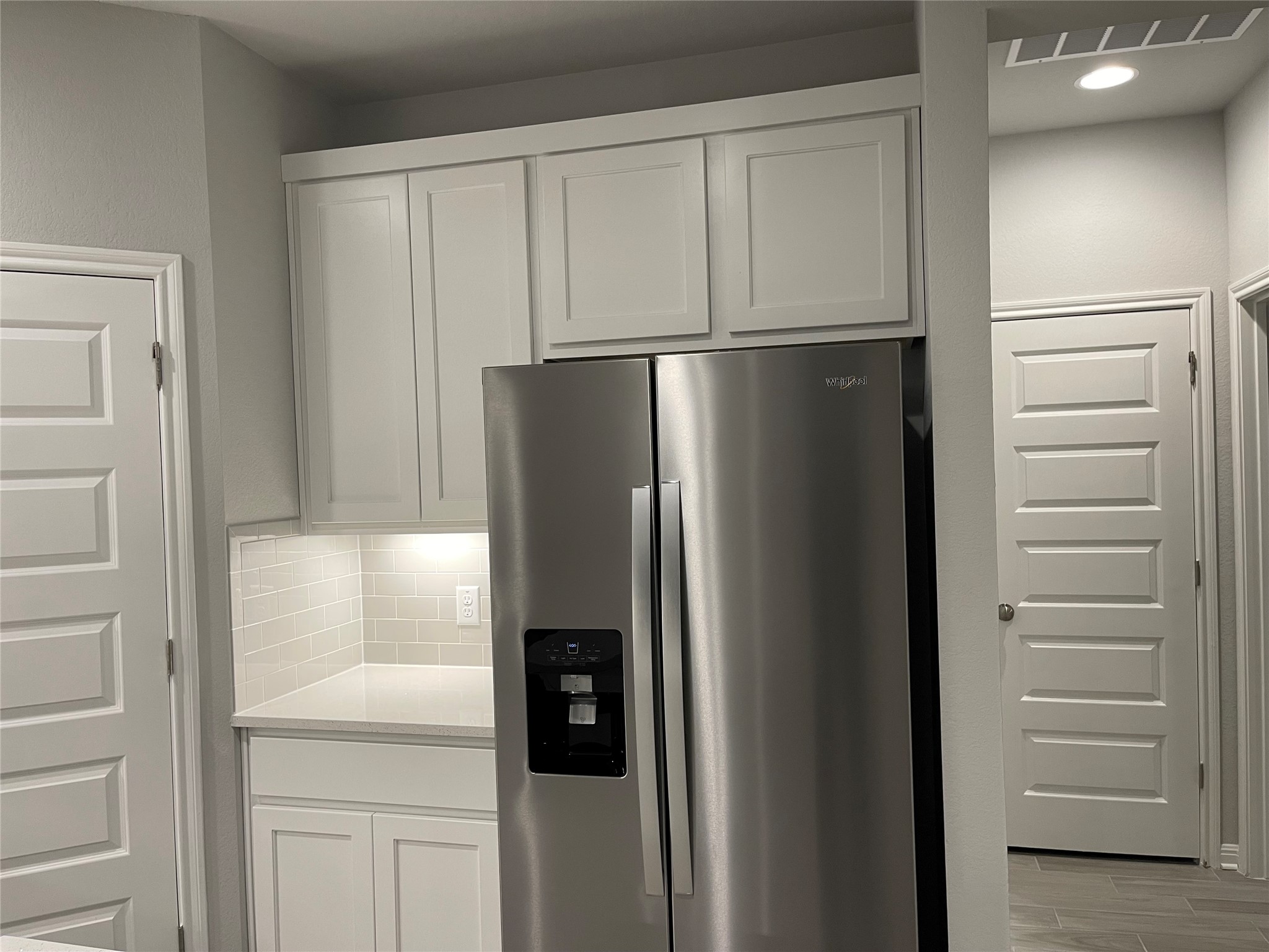 316 Mclintock Road Jarrell, TX 76537 - Photo 6 of 40 a view of a refrigerator in kitchen and white cabinets