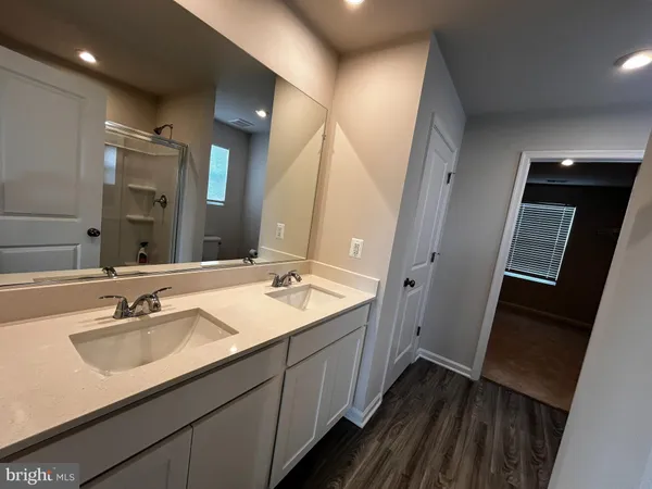 a bathroom with a double vanity sink and mirror