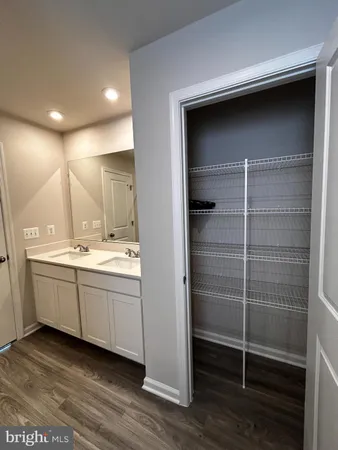 a bathroom with a double vanity sink and mirror