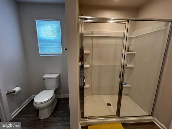 a bathroom with a toilet and a shower