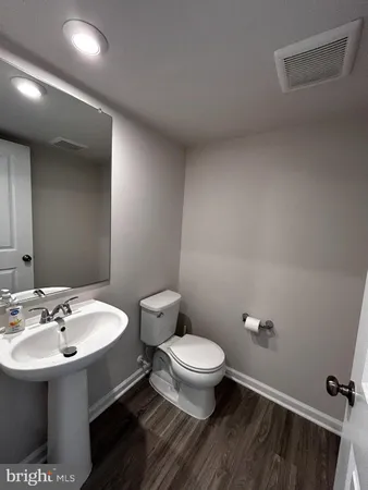 a bathroom with a sink a toilet and mirror