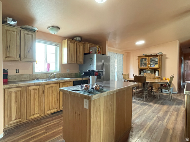 240 Horseshoe Bend Road Vernal, UT 84078 - Photo 9 of 41 Kitchen with tile countertops, freestanding refrigerator, a center island, and dark wood-style floors