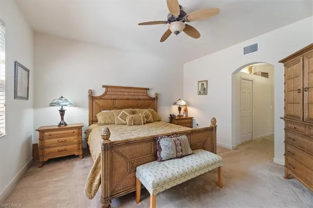 a bedroom with furniture and a ceiling fan