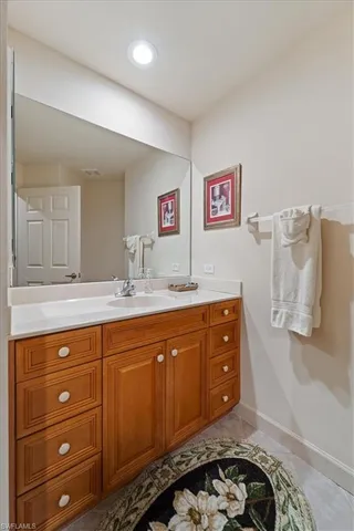 a spacious bathroom with a sink and a mirror