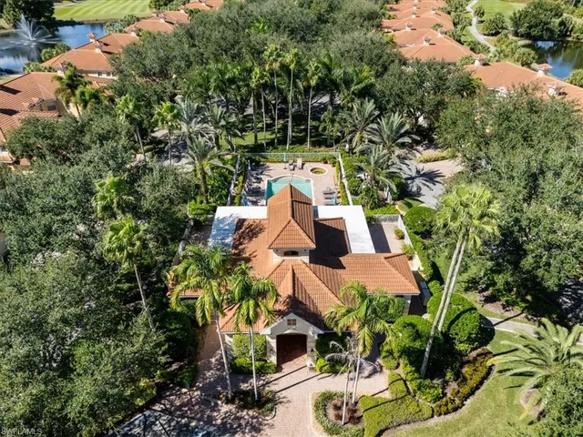 an aerial view of a house with yard swimming pool and outdoor seating