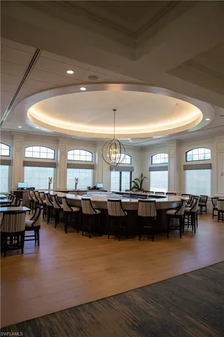 a living room with lots of furniture and kitchen view
