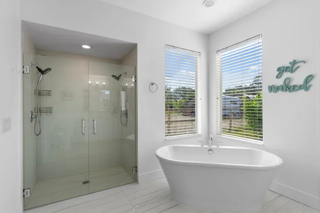 a bathroom with a bathtub and a shower