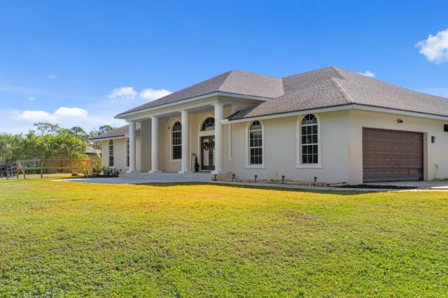 a view of a swimming pool with an outdoor space and seating area
