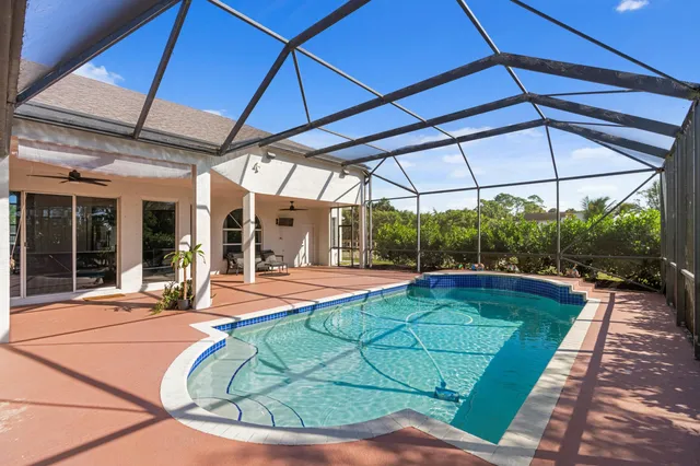 a view of a backyard patio with swimming pool table and chairs