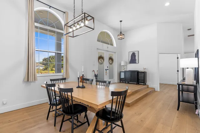 a view of a dining room with furniture wooden floor and a chandelier