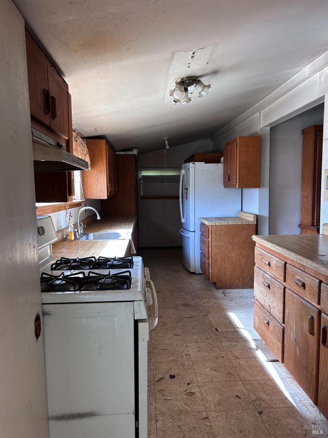1005 Poplar Road Vacaville, CA 95687 - Photo 14 of 17 a kitchen with stainless steel appliances granite countertop a stove and a refrigerator