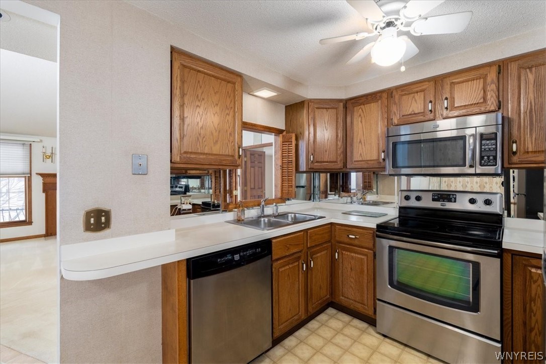 610 Youngs Road, Unit H Amherst, NY 14221 - Photo 7 of 19 Kitchen features a pass through into the Living Ro
