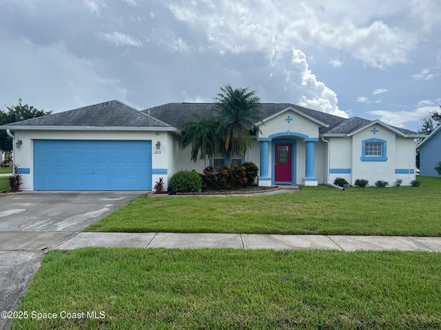 a front view of house with yard and green space