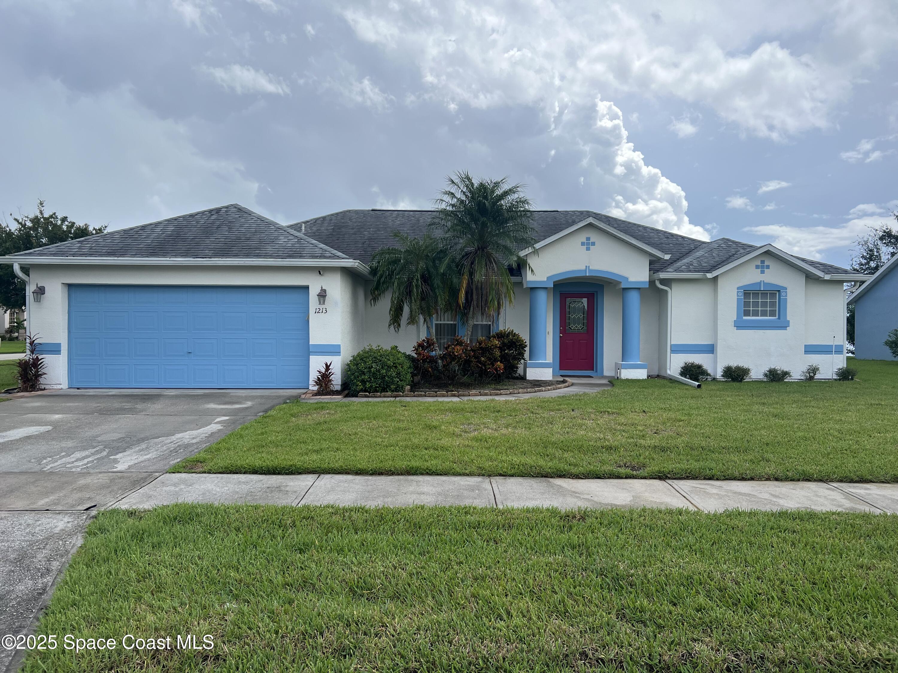 a front view of house with yard and green space