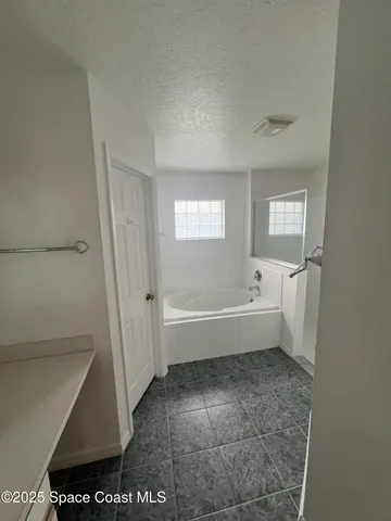 a bathroom with a bathtub a toilet and a shower