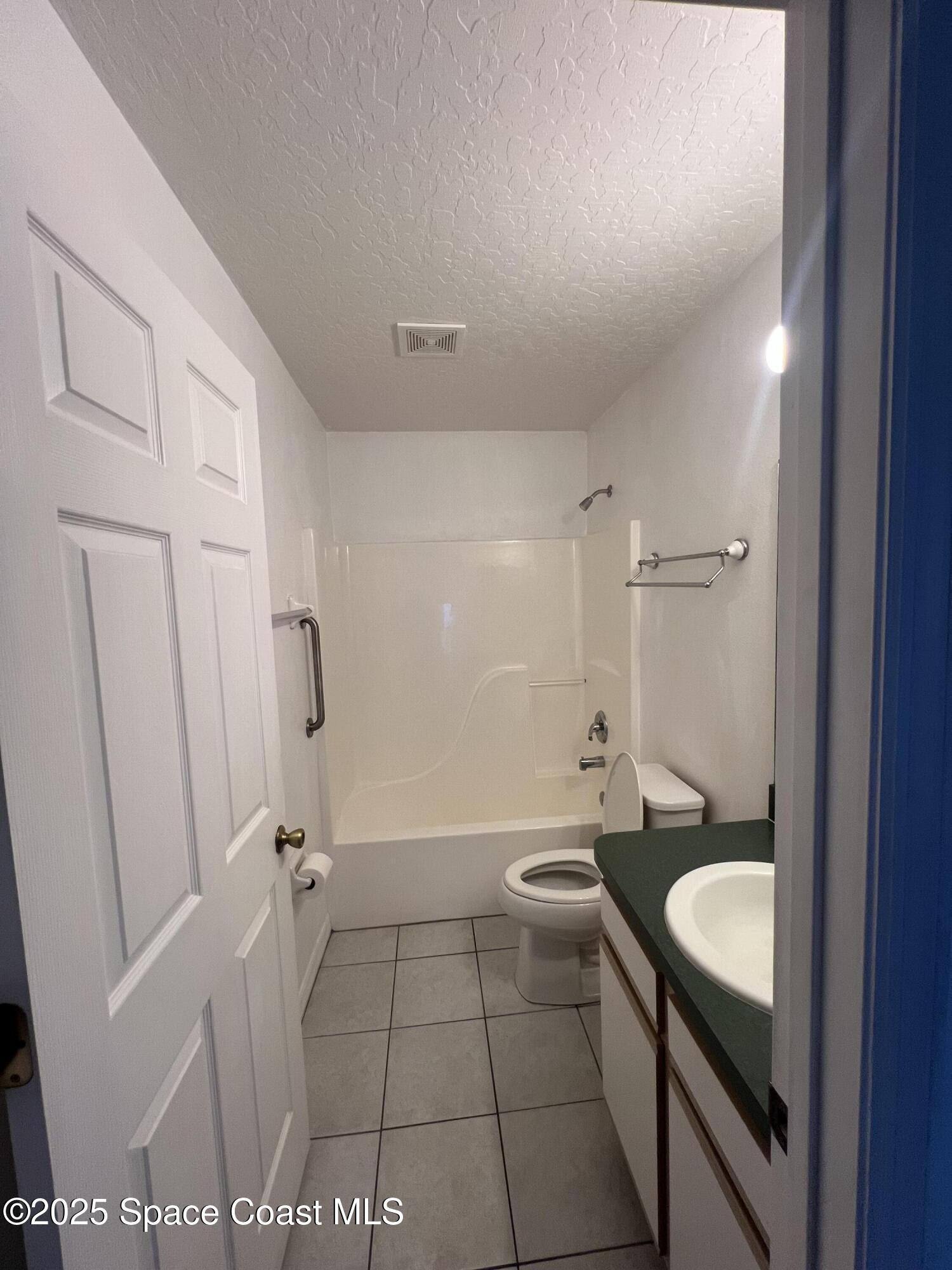 1213 Old Millpond Road Melbourne, FL 32940 - Photo 15 of 20 a bathroom with a sink a toilet and shower