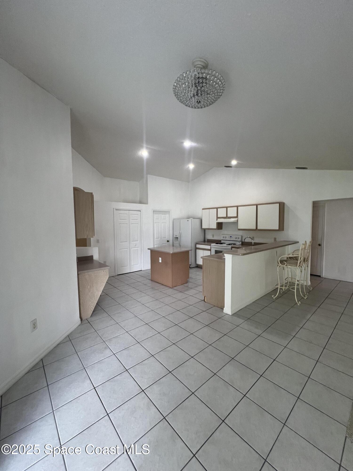 1213 Old Millpond Road Melbourne, FL 32940 - Photo 5 of 20 a kitchen with stainless steel appliances granite countertop a refrigerator sink and cabinets