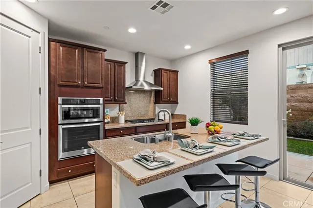 a kitchen with a stove a refrigerator and a dining table