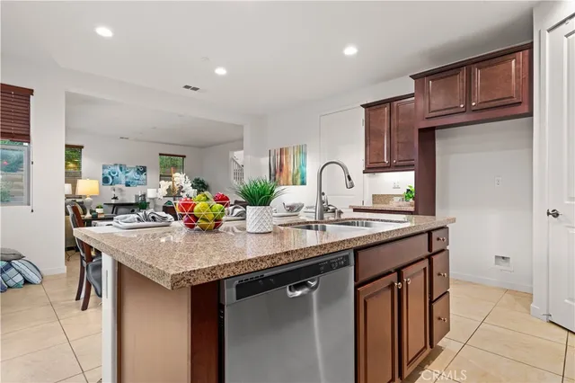 a kitchen with stainless steel appliances granite countertop a sink a stove and a refrigerator