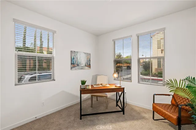 a living room with furniture and windows