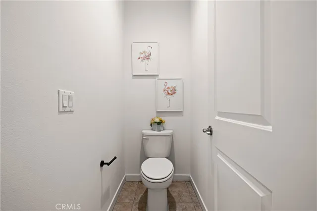 a white toilet sitting next to a white sink