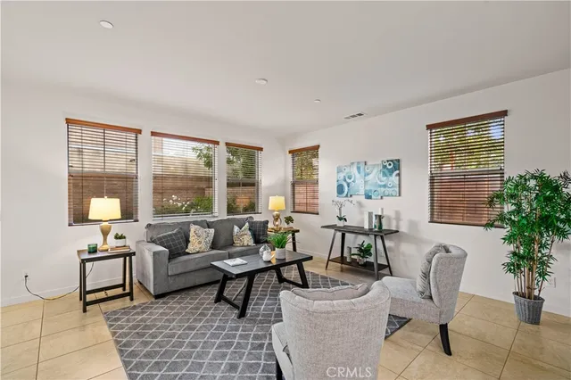 a living room with furniture and a potted plant