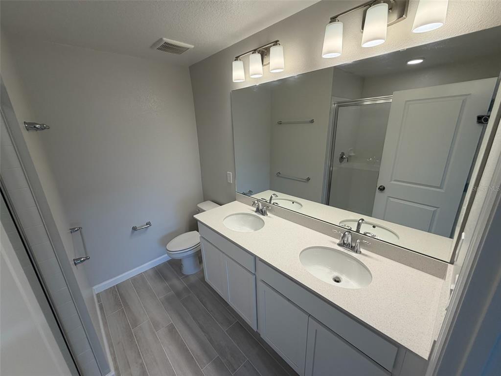 4632 Campsite Loop Orlando, FL 32824 - Photo 12 of 22 a bathroom with a sink mirror and toilet