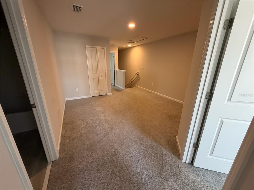 4632 Campsite Loop Orlando, FL 32824 - Photo 7 of 22 a view of a hallway to rooms