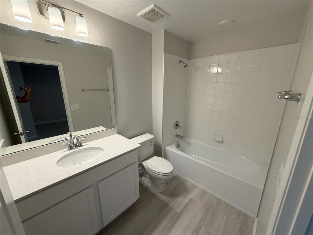 4632 Campsite Loop Orlando, FL 32824 - Photo 9 of 22 a bathroom with a sink a toilet and shower