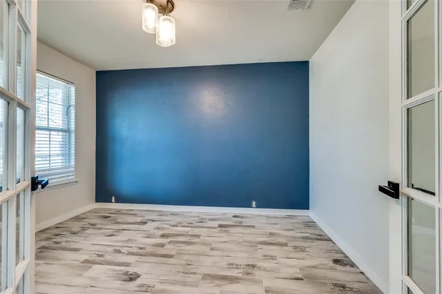 a view of a livingroom with a dishwasher and wooden floor