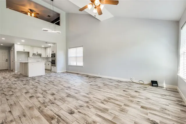 a view of kitchen and empty room