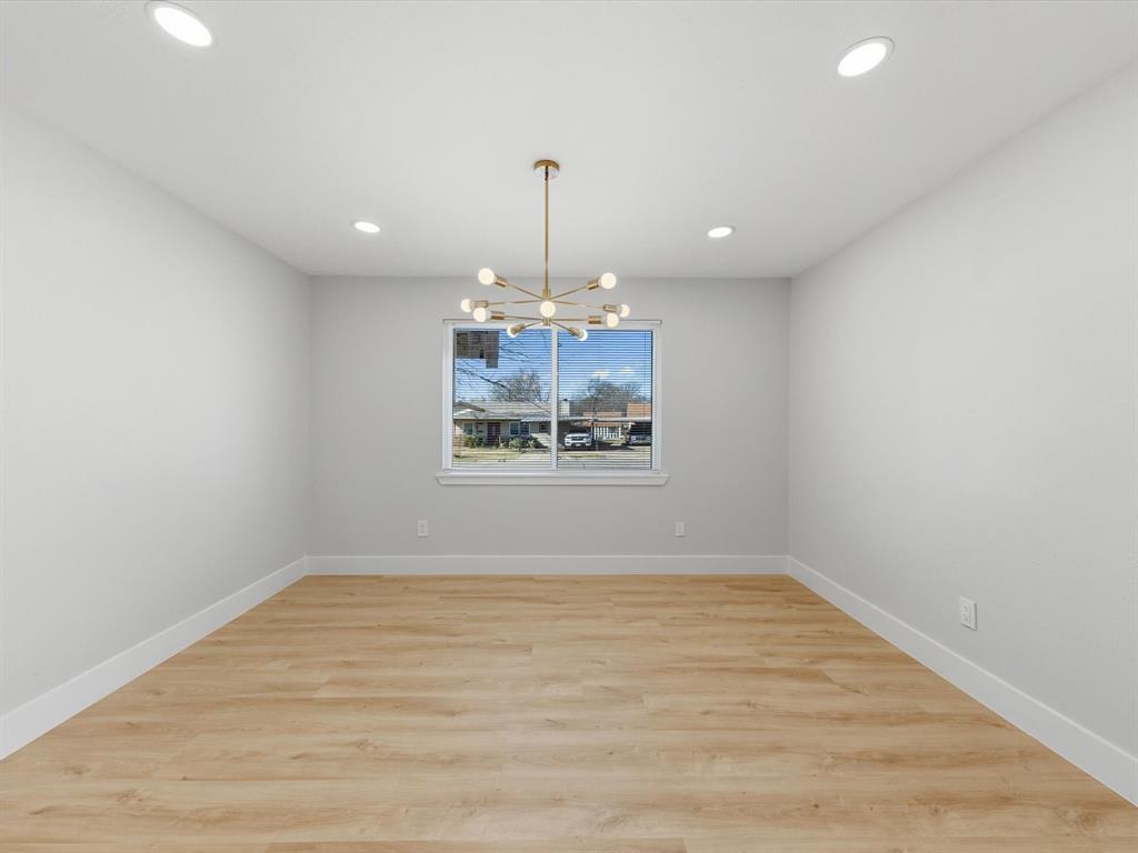 4013 Oleander Trail Mesquite, TX 75150 - Photo 10 of 28 Unfurnished room with light wood finished floors, a chandelier, and recessed lighting