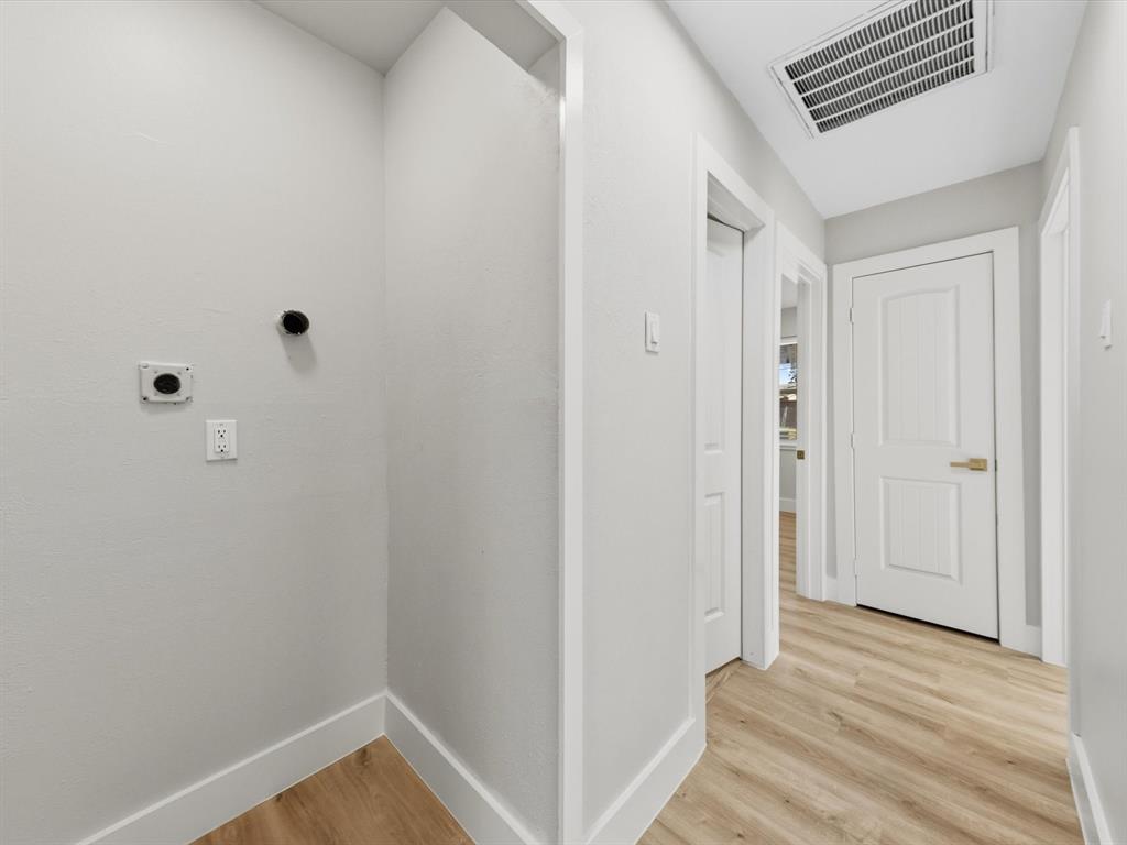 4013 Oleander Trail Mesquite, TX 75150 - Photo 20 of 28 Laundry room featuring light wood-style flooring and hookup for an electric dryer